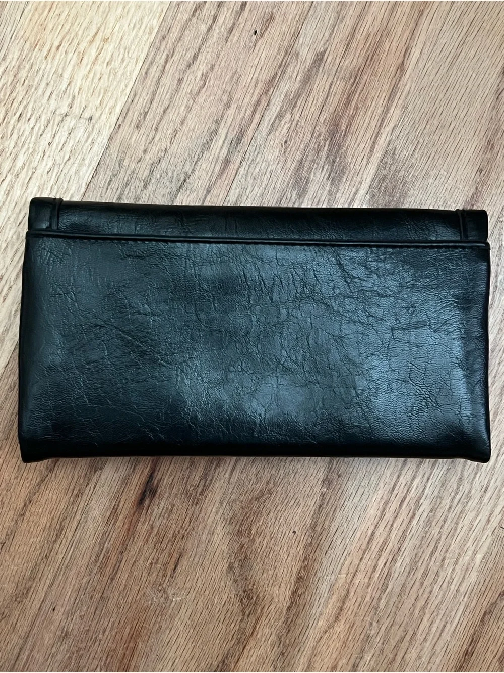Black Fold-Over Clutch Wallet new without tags. Never used. Genuine leather